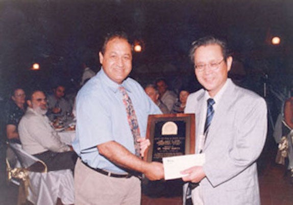 Tadao Murata receives award plaque